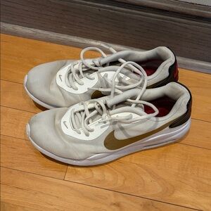 Nike White Mesh Sneakers with Gold Swoosh Accent